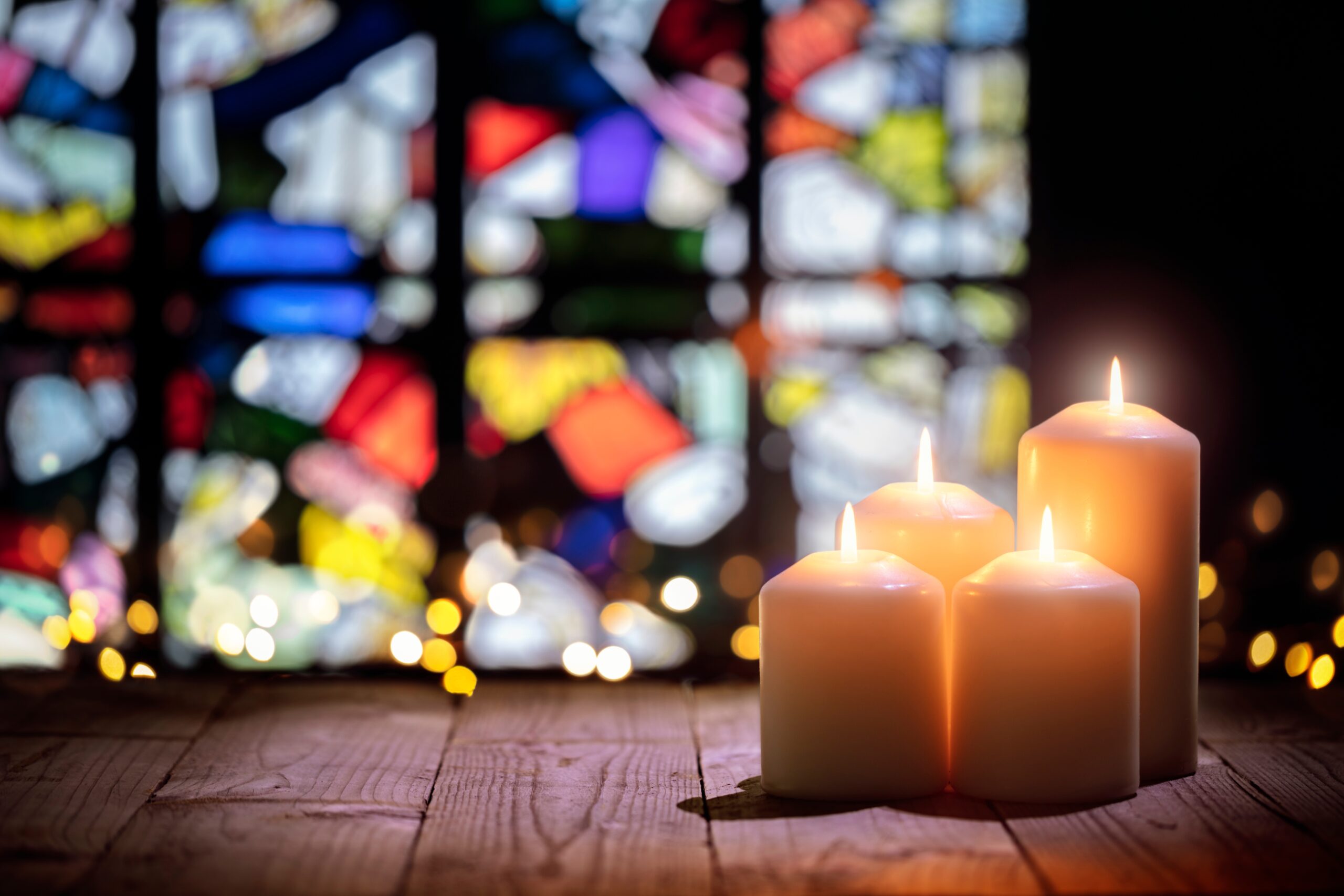 picture of candles in front of stained window